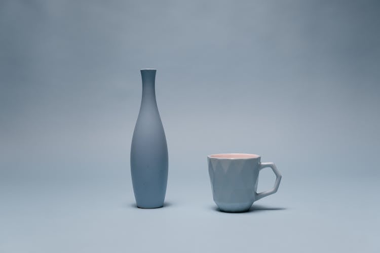 Blue Ceramic Pitcher On Gray Surface