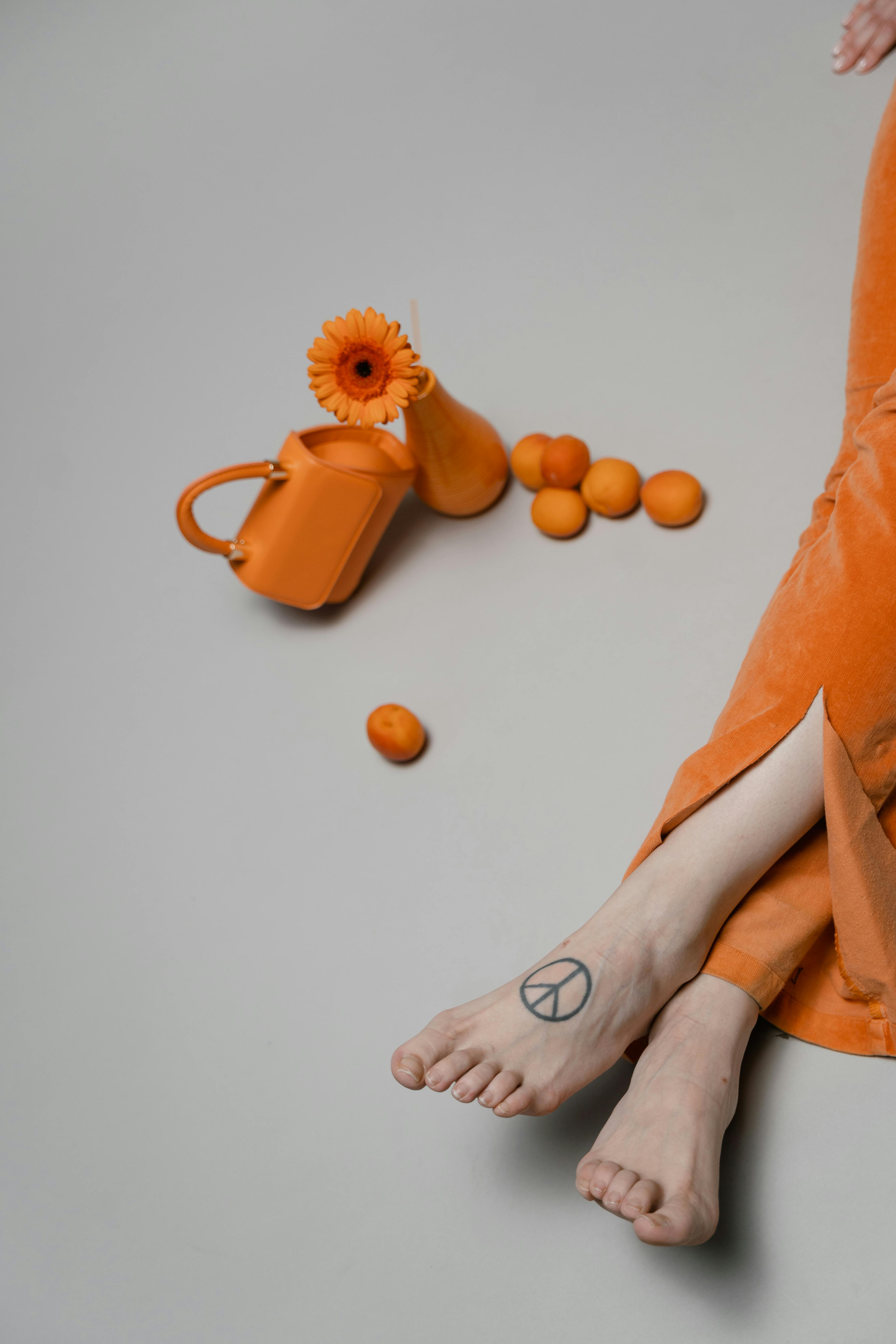 overhead shot of person s feet near orange elements