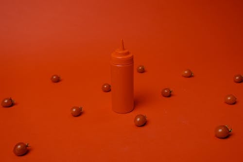 Orange Plastic Bottle on Orange Surface