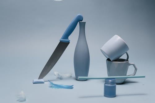 Blue and Silver Kitchen Knife Beside White Ceramic Mug