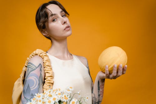 Free Close-up Photo of Woman holding a Yellow Melon  Stock Photo
