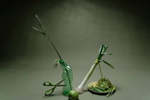 A serene still life composition with green vegetables and fruits on a muted background.