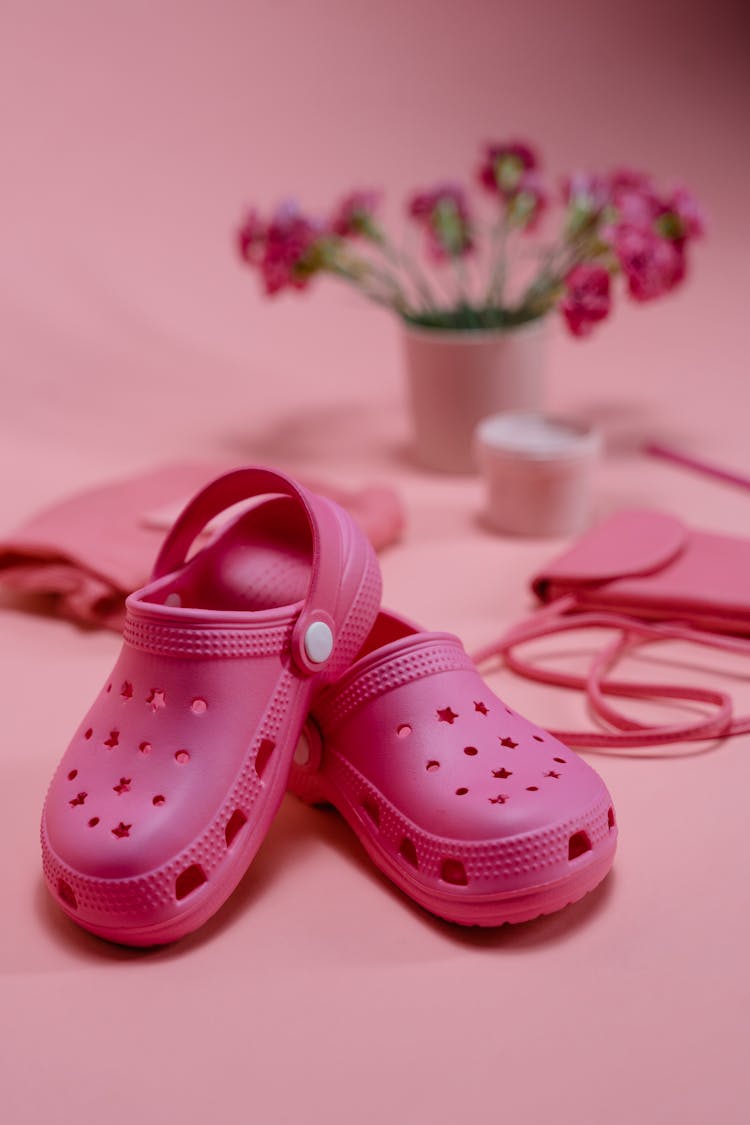 Pink Rubber Clogs Beside The Pink Small Bags 