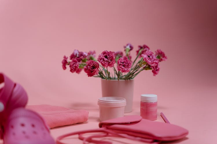 A Bunch Of Pink Flowers In Pink Pot On Pink Background