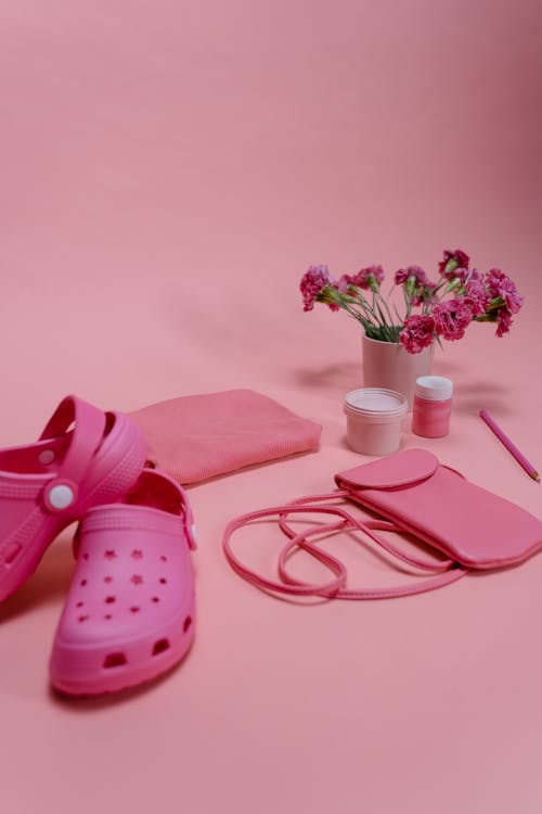 Pink Rubber Clogs Beside Pink Rose