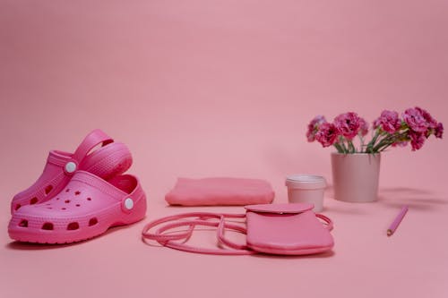 Free Sling Bag and Sandals on Pink Surface Stock Photo