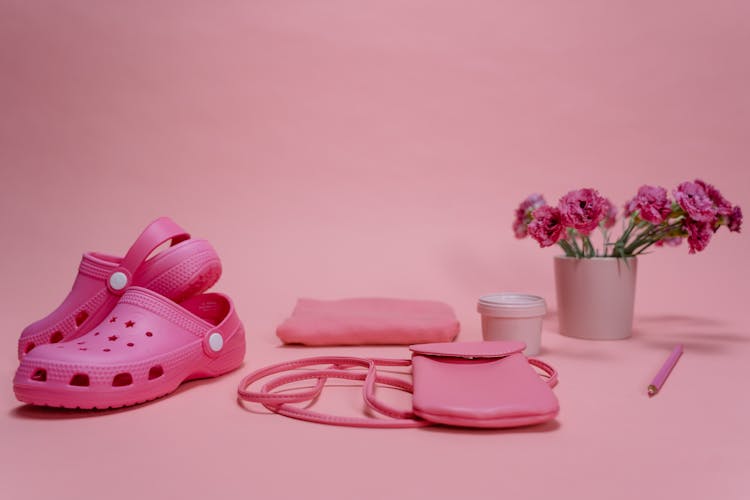 Sling Bag And Sandals On Pink Surface