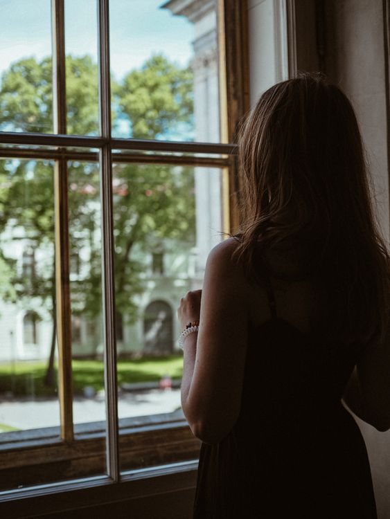 Woman Standing In Window Woman Standing Beside a Glass Window · Free Stock Photo