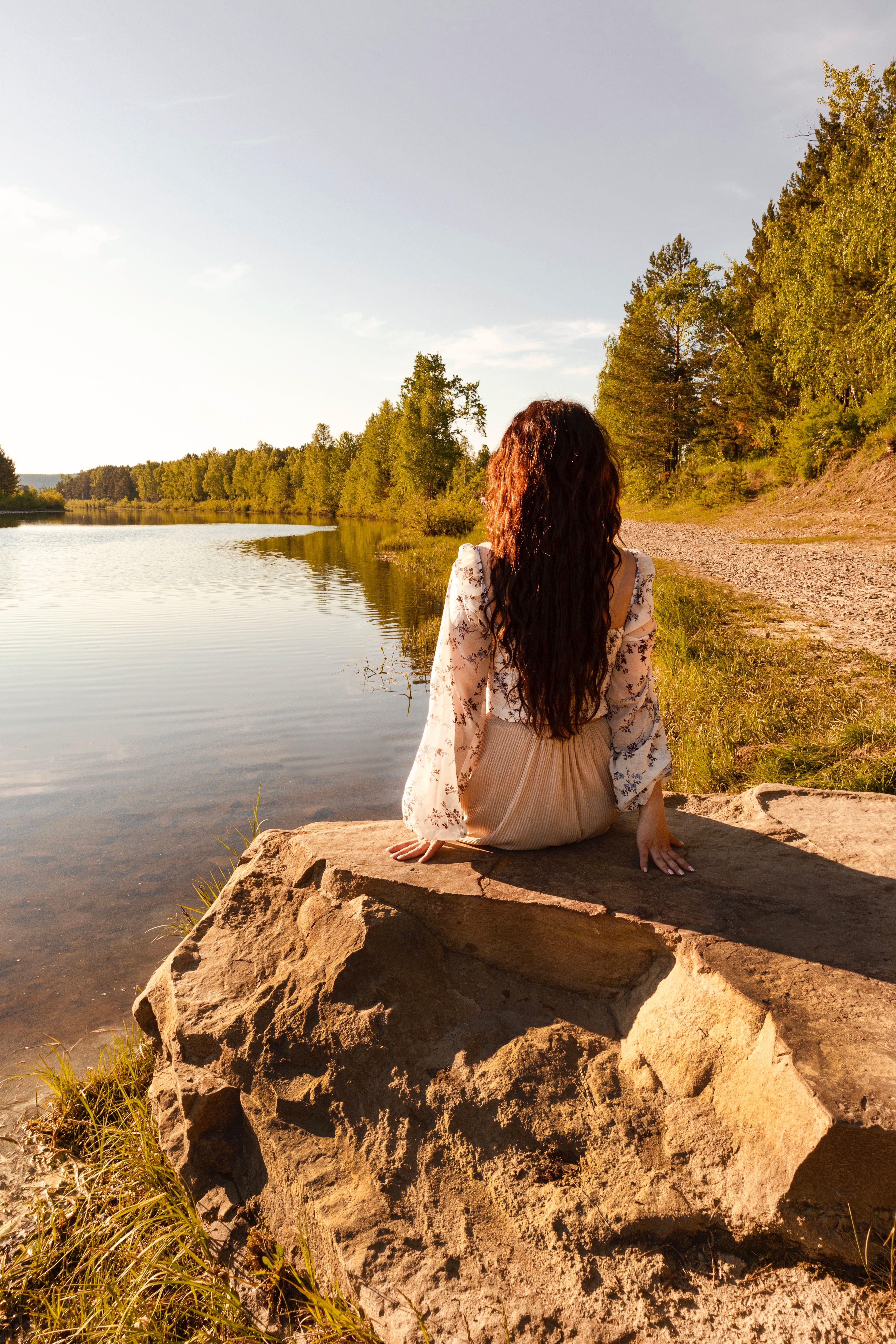 Woman Sitting on a Rock Beside the Lake · Free Stock Photo