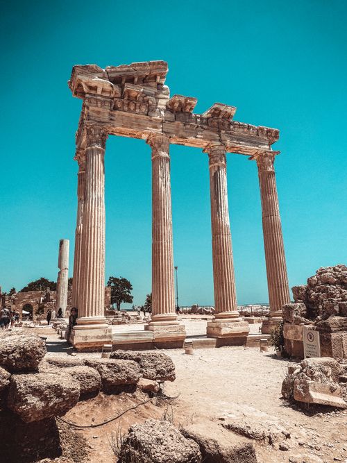 Free Explore ancient architectural marvels with towering columns under a bright blue sky. Stock Photo