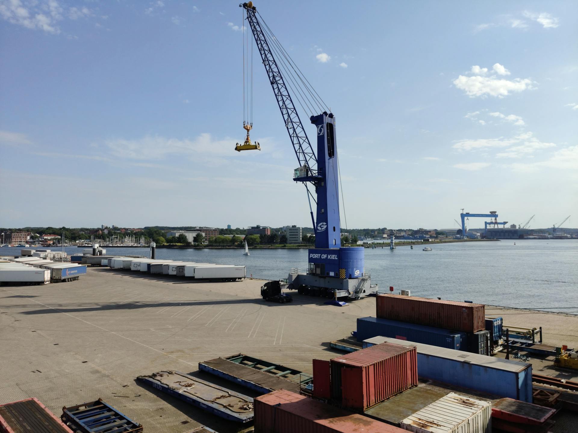 A crane loads containers at the bustling Port of Kiel.