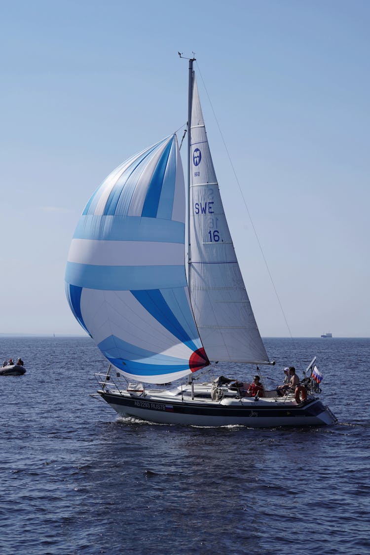 People In A Sailboat On Sea