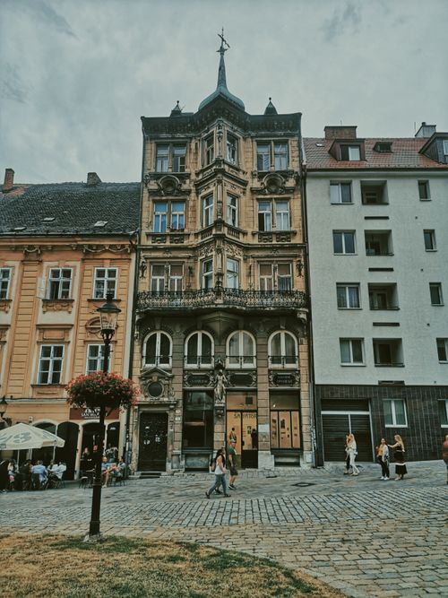 Free Captivating historic building facade in a European city with intricate details and pedestrian street. Stock Photo