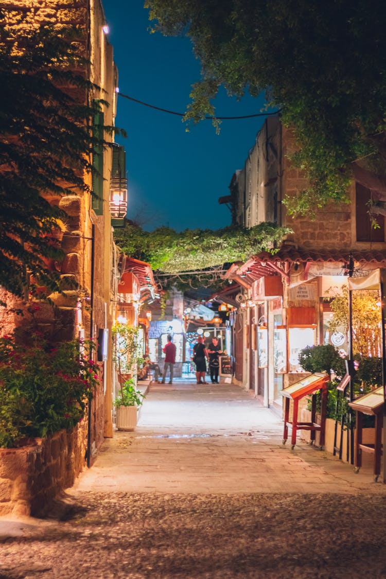 Illuminated Alley Between Restaurants At Night