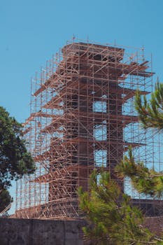 View of a tower under construction surrounded by scaffolding in Rodos.