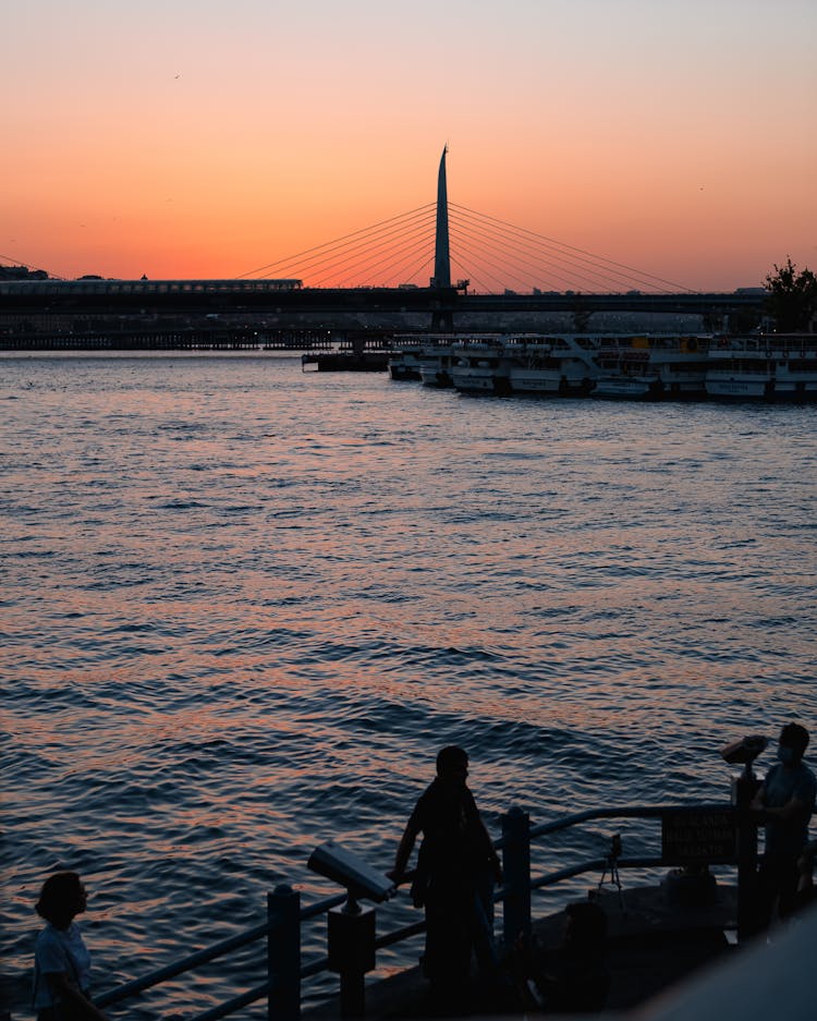 People Watching Sunset Near Water