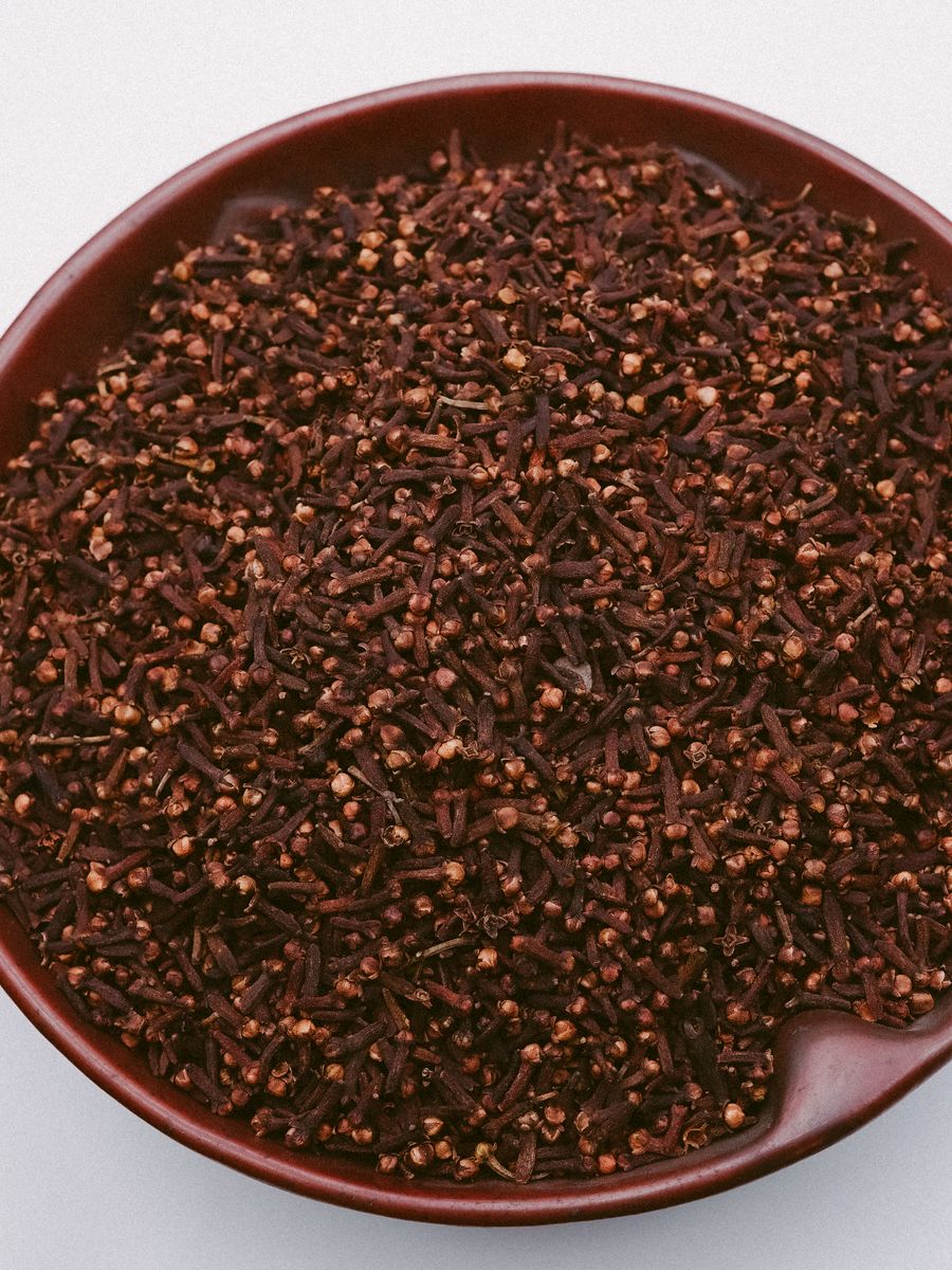Whole dried clove buds filling a bowl
