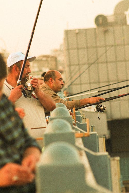 Lined Up Men Holding Fishing Rods