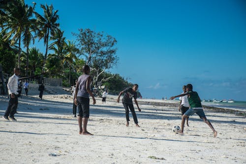 Children Playing Soccer on the Beach