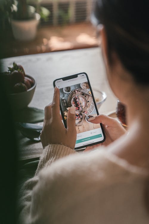 Free A Person Looking at a Photo on a Smartphone  Stock Photo