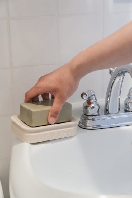 Person Holding a Bar Soap