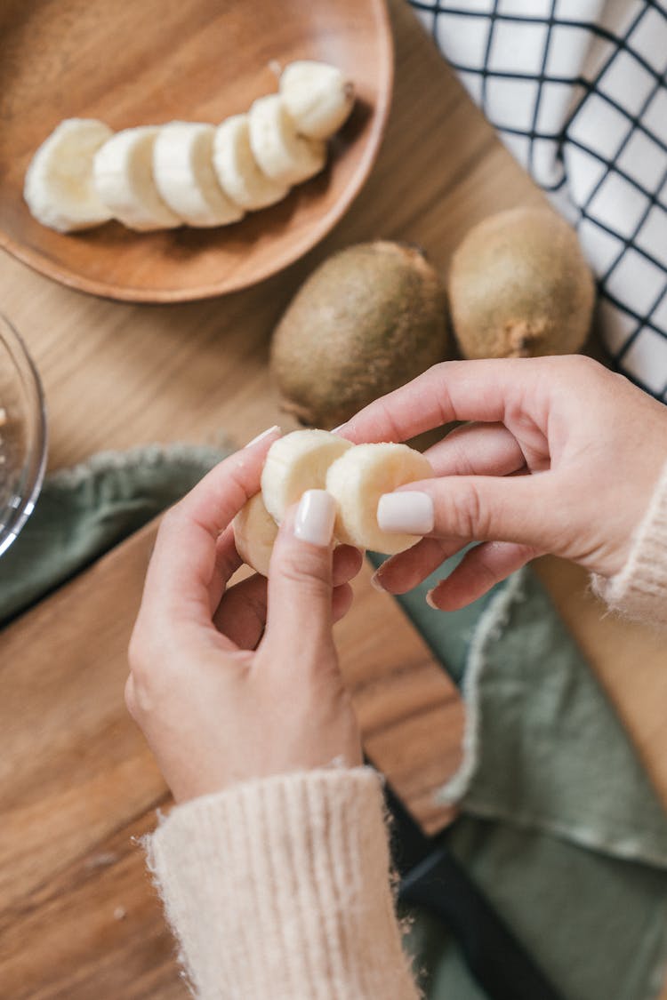 Person Holding Pieces Of Sliced Banana