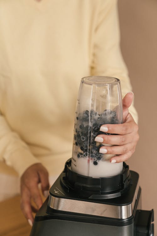 Free Person Using a Juice Blender Stock Photo