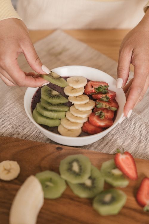 Free Close-up of a chia pudding bowl topped with fresh sliced fruits including banana, kiwi, and strawberries. Healthy lifestyle. Stock Photo