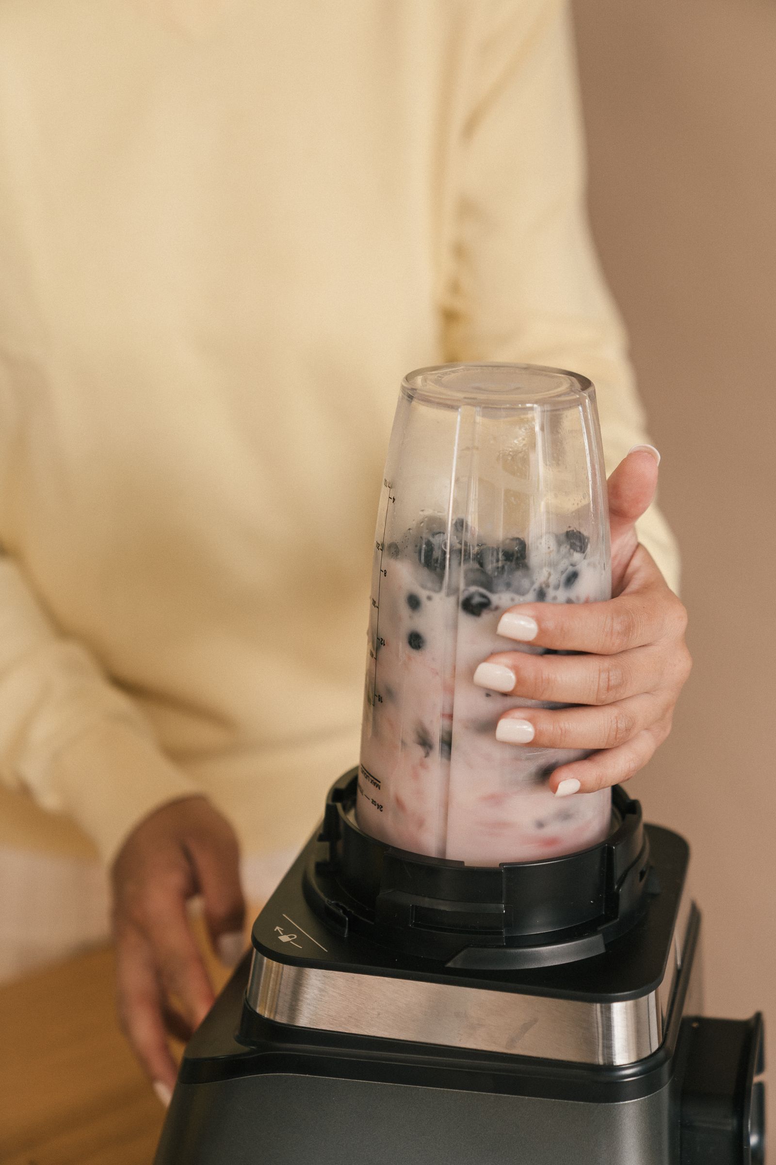 Berry smoothie ingredients being blended in a kitchen