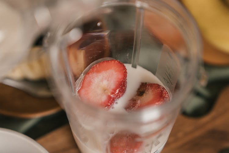 Sliced Strawberries With Milk In A Clear Container