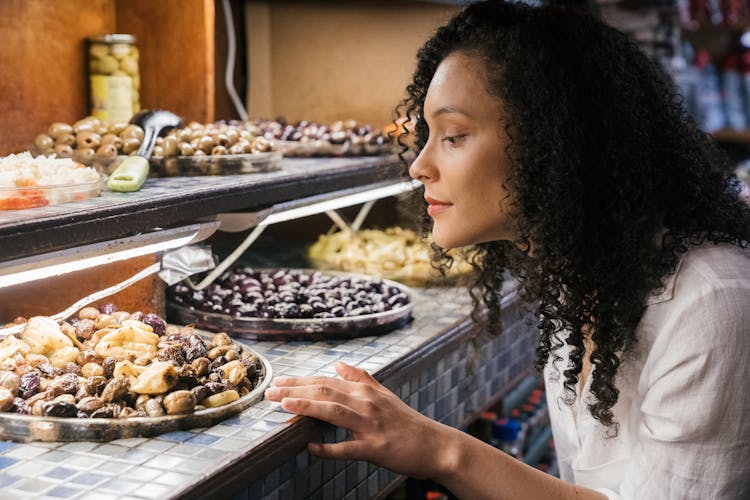 Woman Looking At Food On A Buffet Display 