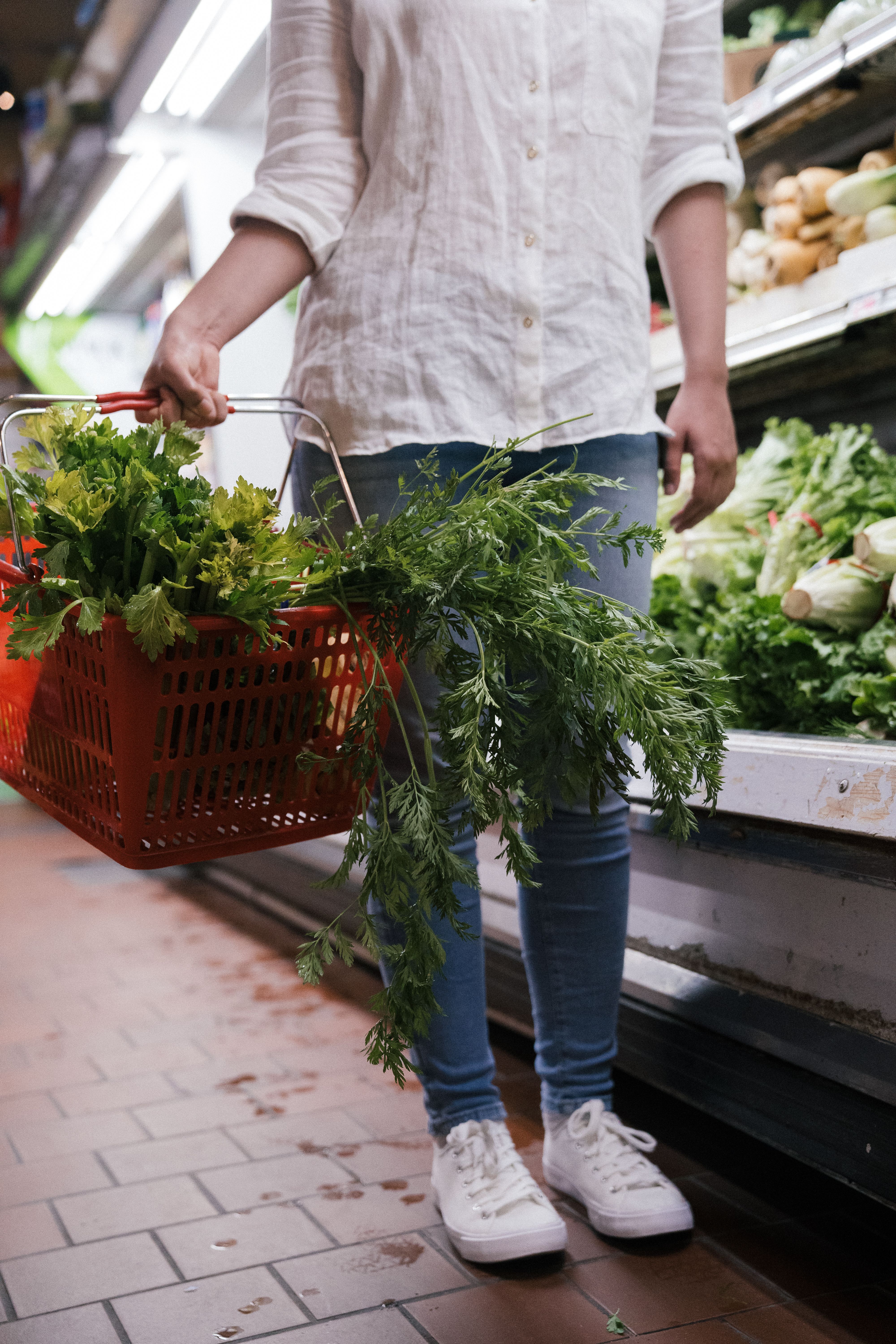 Happy grocery shopper holding vegetables
