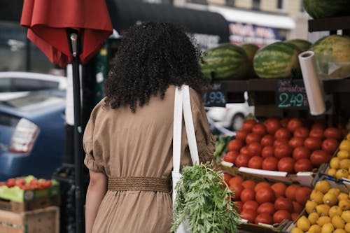 Free Woman in Brown Blouse Buying Fresh Fruits on a Stall Stock Photo