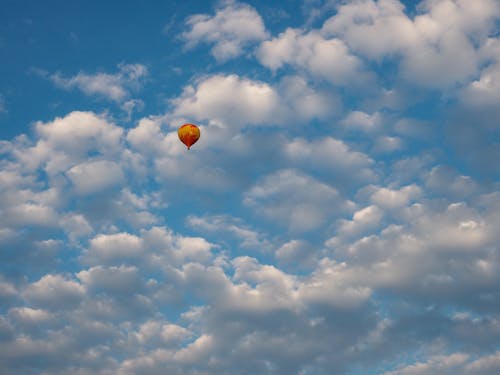 Orange and Yellow Hot Air Balloon in the Sky