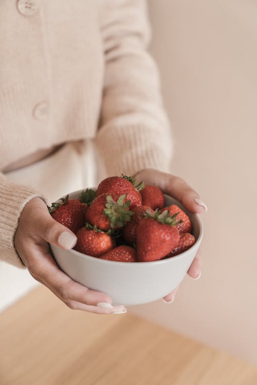 Free Person Holding Red Strawberries in White Ceramic Bowl Stock Photo