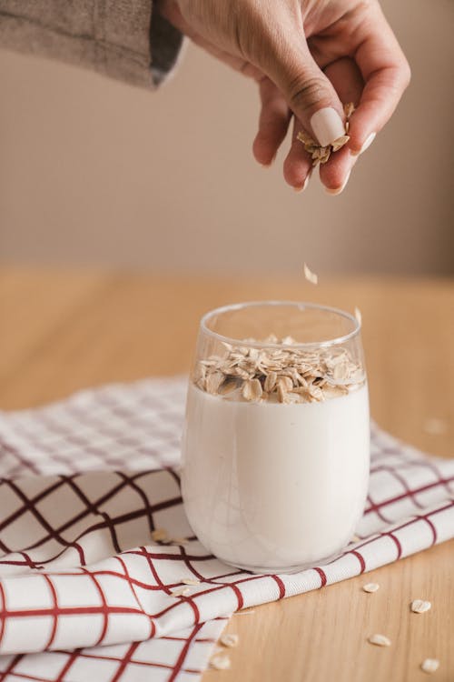 Free Person sprinkling Oats in a Glass of Smoothie Stock Photo