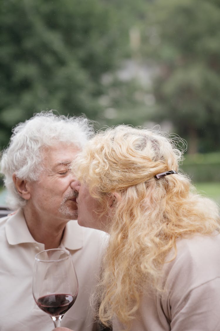 Senior Man And Blonde Woman Kissing On Lips 