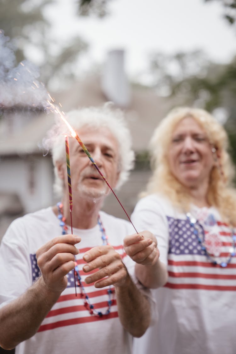 Elderly Couple Holding Sparklers 