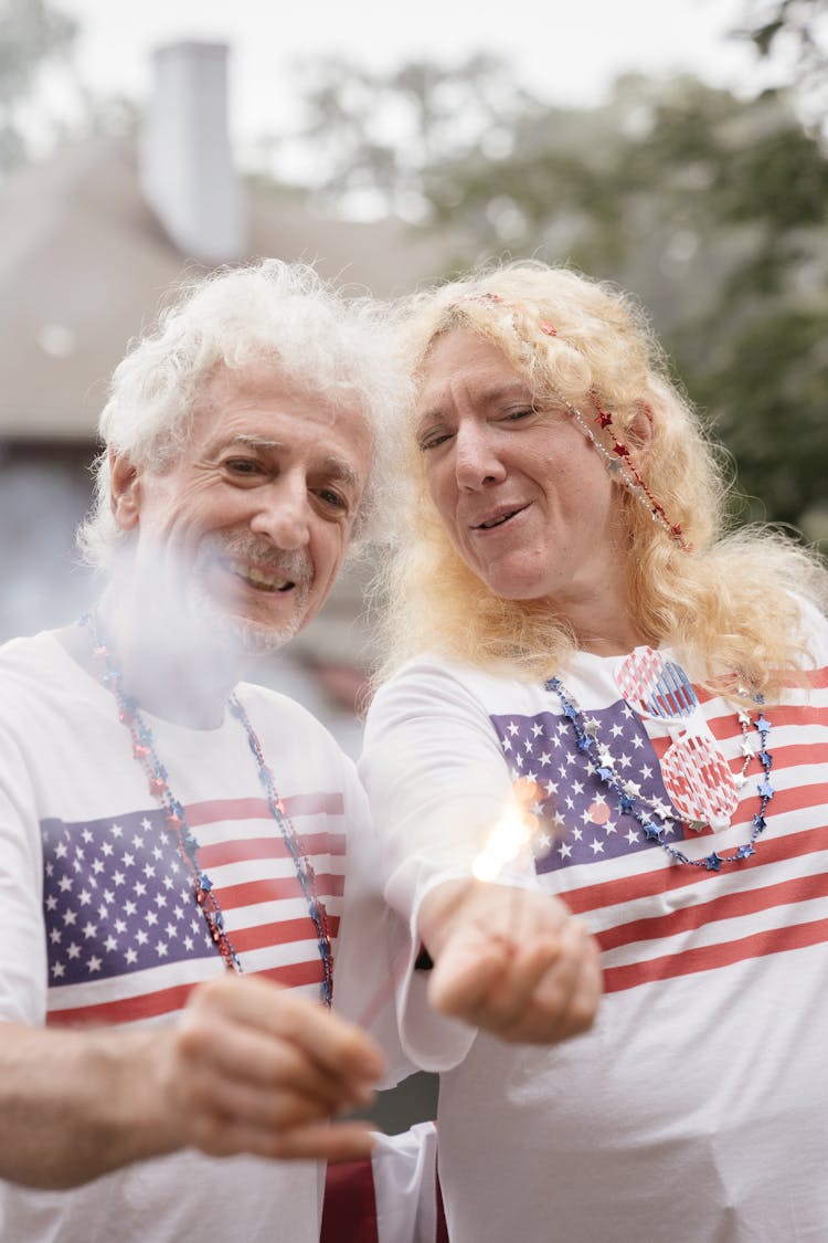 Elderly Couple Holding Sparklers 