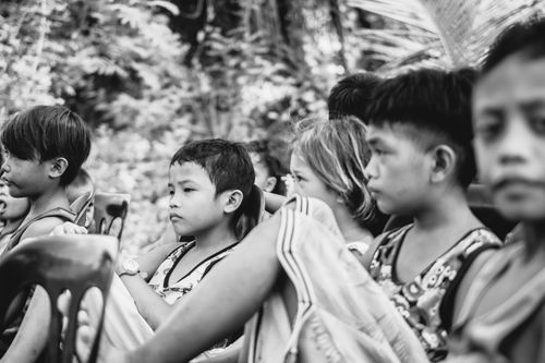 Free Black and white photo of children seated outside, displaying thoughtful expressions. Stock Photo