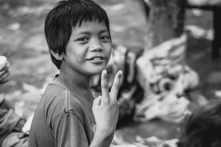 A Child Making The Peace Sign 