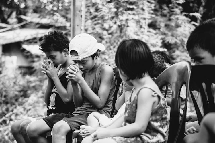 Monochrome Photo Of Children Praying Solemnly 