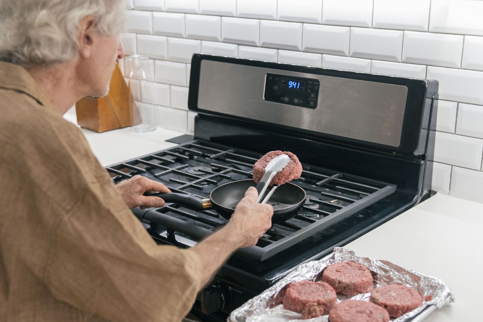Cooked ground beef stored in glass containers inside refrigerator