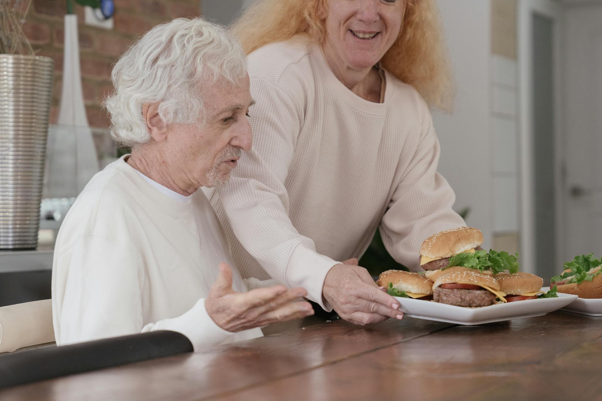 Happy Elderly Couple beside Dining Table 