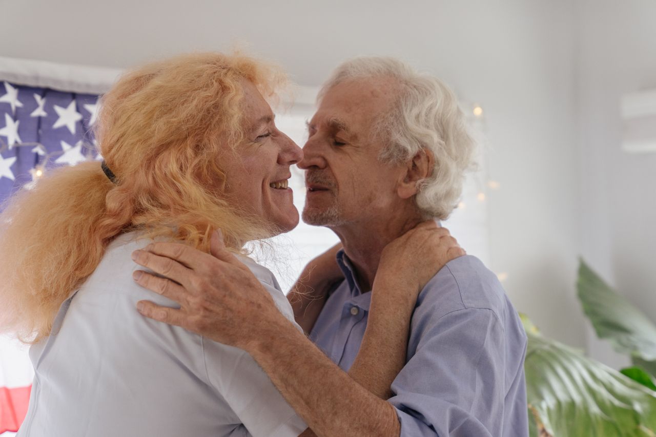 an elderly lgbt couple embracing lovingly indoors radiating intimacy a