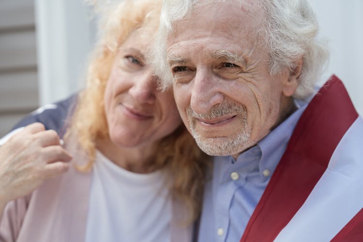 A Couple Draped With The American Flag