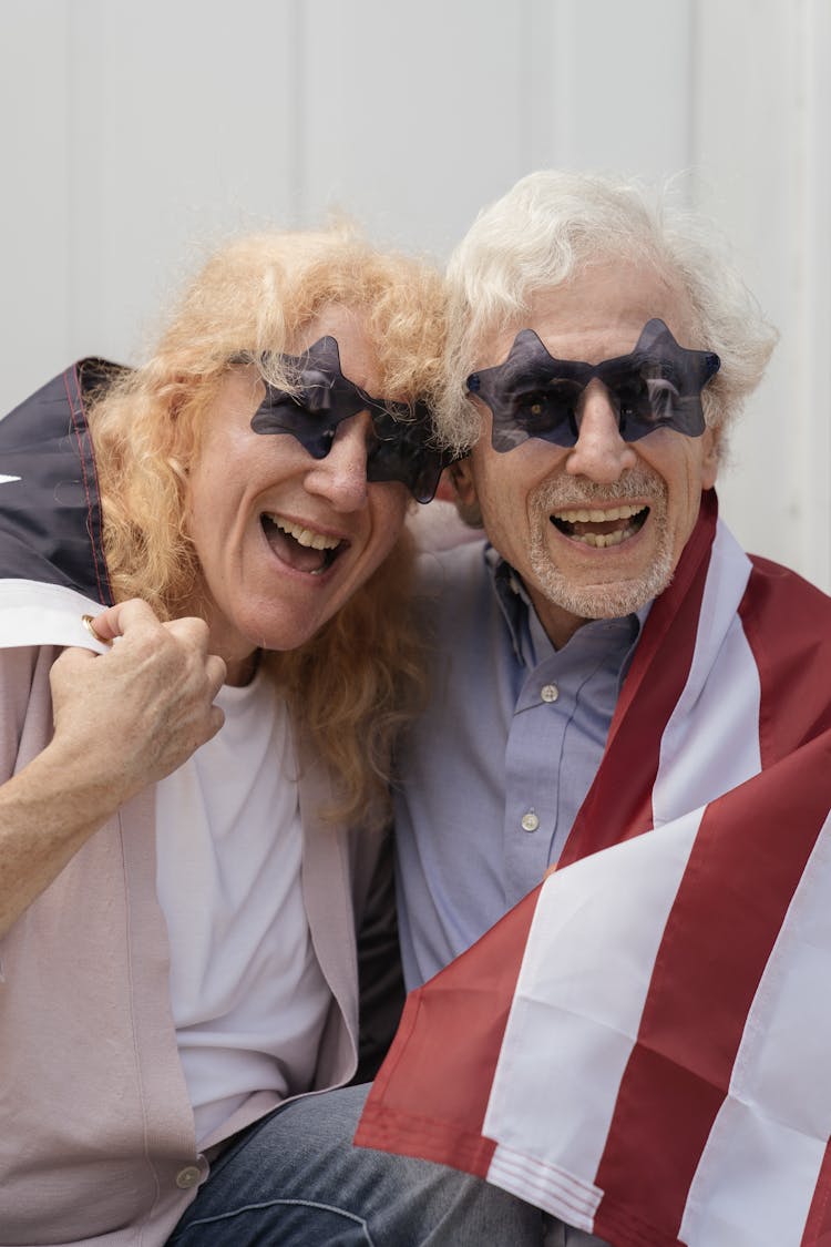 Elderly Couple Wearing Star Shaped Sunglasses