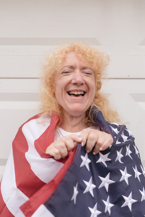 Free Smiling Elderly Woman Wrapped in the American Flag  Stock Photo