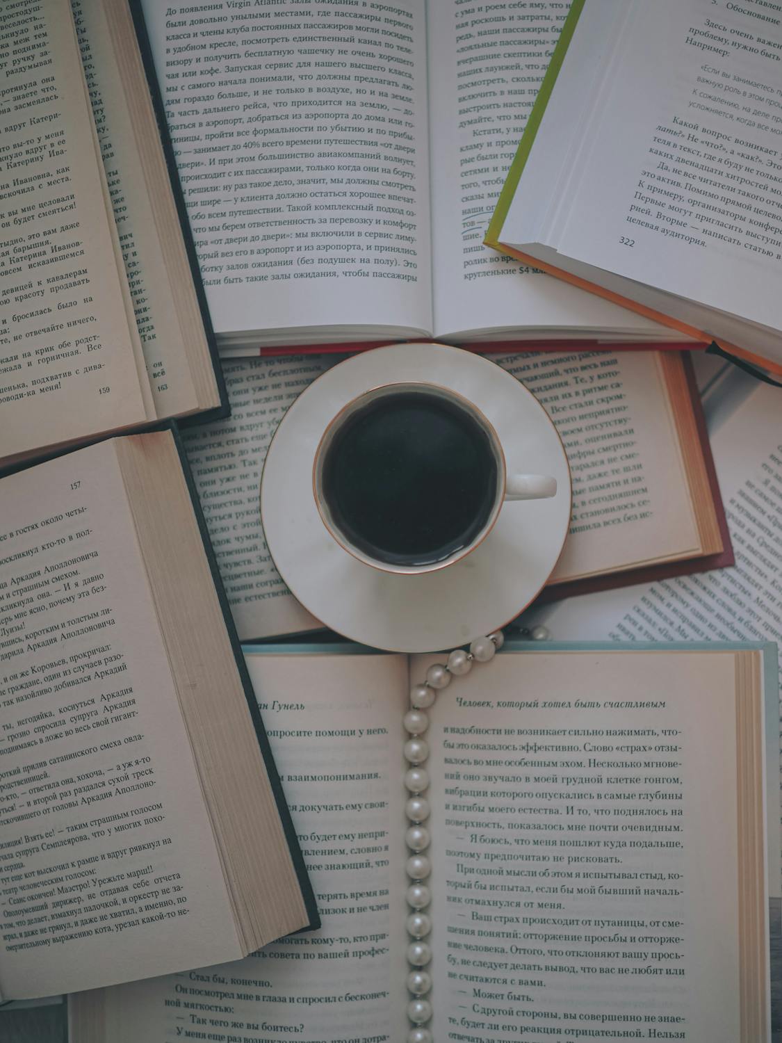 Overhead Shot of a Cup of Black Coffee Beside Books · Free Stock Photo