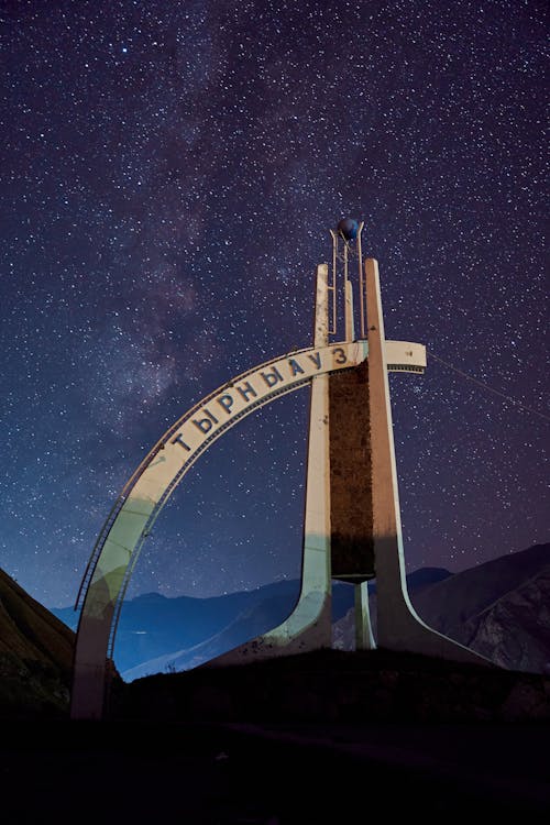 Concrete Building Under Blue Starry Sky during Night Time